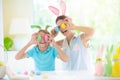 Mother and kids, family coloring Easter eggs Royalty Free Stock Photo