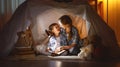 Mother and child daughter with a book and a flashlight before go Royalty Free Stock Photo