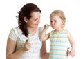 Mother and child daughter brushing teeth in bathroom Royalty Free Stock Photo