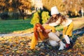 Mother and child daughter playing outdoors. Autumn sunny weather. Redhead woman and child walking in the autumn park Royalty Free Stock Photo