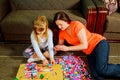 Mother and child daughter playing together, build from the constructor. cute her son play Royalty Free Stock Photo