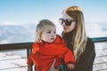 Mother with child daughter traveling together family winter vacation mom with baby