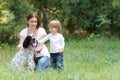 Mother and child with dog outdoors