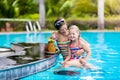 Mother and child drink juice in swimming pool Royalty Free Stock Photo