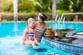 Mother and child drink juice in swimming pool Royalty Free Stock Photo