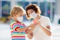 Mother and child with face mask and hand sanitizer Royalty Free Stock Photo