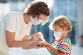 Mother and child with face mask and hand sanitizer Royalty Free Stock Photo