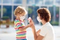 Mother and child with face mask and hand sanitizer Royalty Free Stock Photo