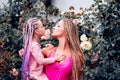 Mother and child girl playing kissing and hugging. Lifestyle portrait mom and daughter in happy mood at the outside Royalty Free Stock Photo