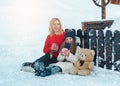 Young family with thermos and cups of tea in hands winter outdoors