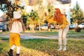 Mother and child girl throwing leaves in autumn park. Autumn holidays, lifestyle, childhood Royalty Free Stock Photo