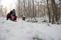 Mother and child going downhill on a snow sledge