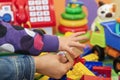 Mother and child hand on a colored toys background Royalty Free Stock Photo