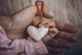 Mother and child hands holding white heart, health care love and family concept. World humanitarian day theme Royalty Free Stock Photo