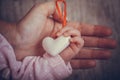 Mother and child hands holding white heart, health care love and family concept. World humanitarian day theme Royalty Free Stock Photo