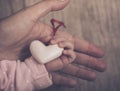 Mother and child hands holding white heart, health care love and family concept. World humanitarian day theme Royalty Free Stock Photo