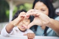 Mother, child and heart hands for love, care or compassion together in the outdoors. Mom and little kid putting hand for Royalty Free Stock Photo