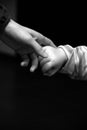 Mother and child holding hands in black and white Royalty Free Stock Photo