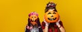 Mother and child holding jack-o-lantern pumpkins