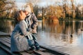 Mother and child hugging at autumn park near the lake. Happy son with mom having fun, relaxing, enjoying life. Mothers`s day, fami Royalty Free Stock Photo