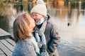 Mother and child hugging at autumn park near the lake. Happy son with mom having fun, relaxing, enjoying life. Mothers`s day, fami Royalty Free Stock Photo