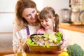 Mother and child jolly look at prepared dish of Royalty Free Stock Photo