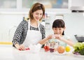Mother and child in kitchen preparing cookies