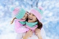 Mother and child in knitted winter hats in snow. Royalty Free Stock Photo