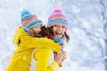 Mother and child in knitted winter hats in snow Royalty Free Stock Photo