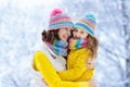 Mother and child in knitted winter hats in snow Royalty Free Stock Photo