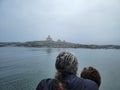 mother and child and lighthouse and rocky shore on the coast of Maine