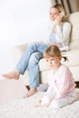 Mother and child in living room watch television Royalty Free Stock Photo