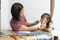 Mother and child make a mask at home