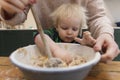 Mother and child mixing ingredients in a bowl in the kitchen together. Royalty Free Stock Photo