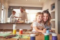 Mother and child painting in family home portrait with father and kid cooking together for creative skills development Royalty Free Stock Photo