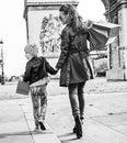 Mother and child in Paris, France looking aside and walking Royalty Free Stock Photo