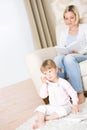 Mother and child - on the phone in living room Royalty Free Stock Photo