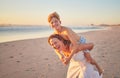 Mother, child and piggy back on beach on summer holiday walking in sea sand. Woman from Australia with son at the ocean Royalty Free Stock Photo