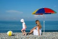 Mother and child play a ball at coast Royalty Free Stock Photo