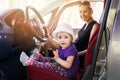 Mother with child playing in the car