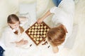 Mother and child are playing chess while spending time together Royalty Free Stock Photo