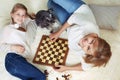 Mother and child are playing chess while spending time together