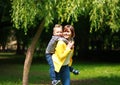 Mother and child playing at summer city park on nature Royalty Free Stock Photo