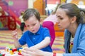 Mother and child playing together, build from the constructor. cute mother and her son play together indoor. Young mom with her ch Royalty Free Stock Photo