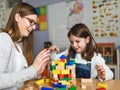 Mother and child Playing together with colorful didactic toys