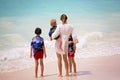 Mother and child playing at tropical beach. Family sea summer vacation. Mom and kid, toddler boy, play in the water. Ocean and Royalty Free Stock Photo