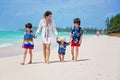 Mother and child playing at tropical beach. Family sea summer vacation. Mom and kid, toddler boy, play in the water. Ocean and Royalty Free Stock Photo