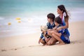 Mother and child playing at tropical beach. Family sea summer vacation. Mom and kid, toddler boy, play in the water. Ocean and Royalty Free Stock Photo