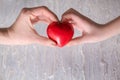 Mother and child with red heart on wooden background. Health care concept Royalty Free Stock Photo