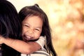 Mother and child resting on her mother`s shoulder